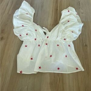 White Ruffled Top with Red Star Accents